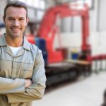 Portrait of confident man standing with arms crossed in factory